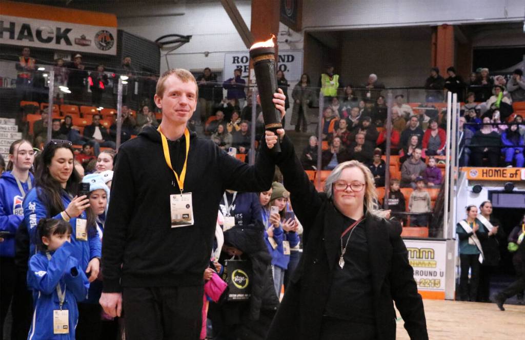 Trail bowler Tim Flack and swimmer Alyssa Berdusco make their way to light the 2026 BC Winter Games cauldron.(Jim Bailey/Trail Times)